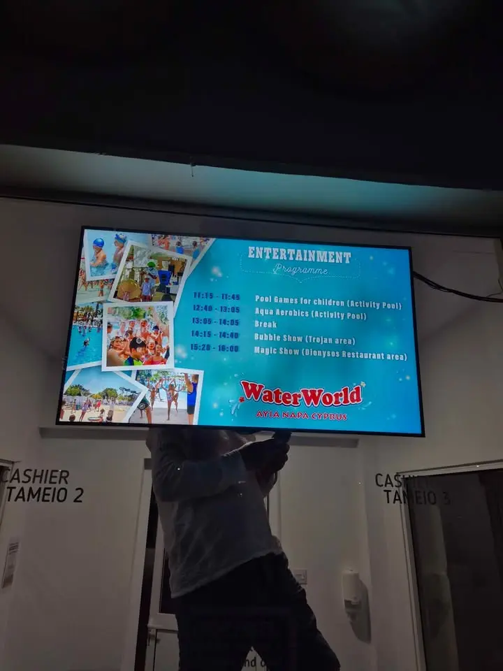 Digital screen in a pharmacy displaying health information and offers.