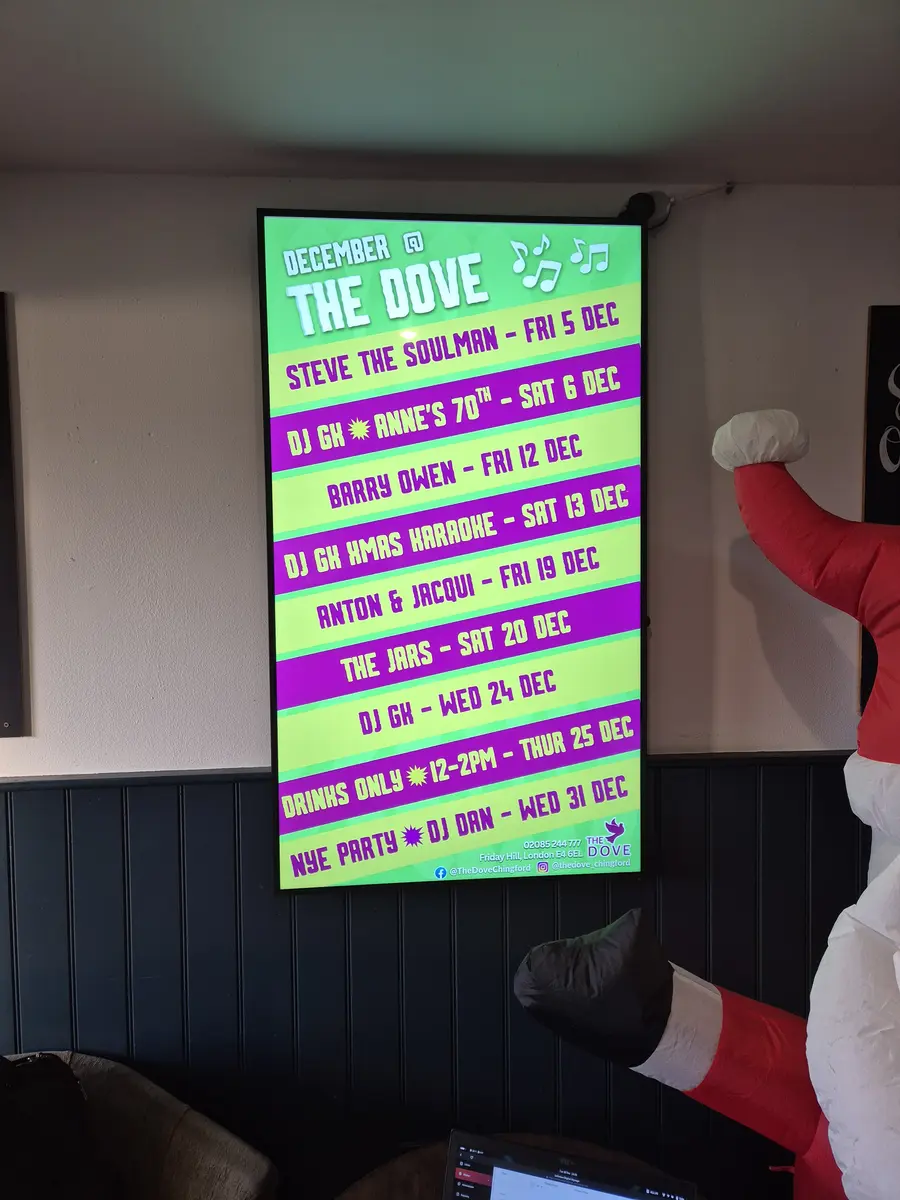 Managed digital signage in a UK pub promoting drinks and events.