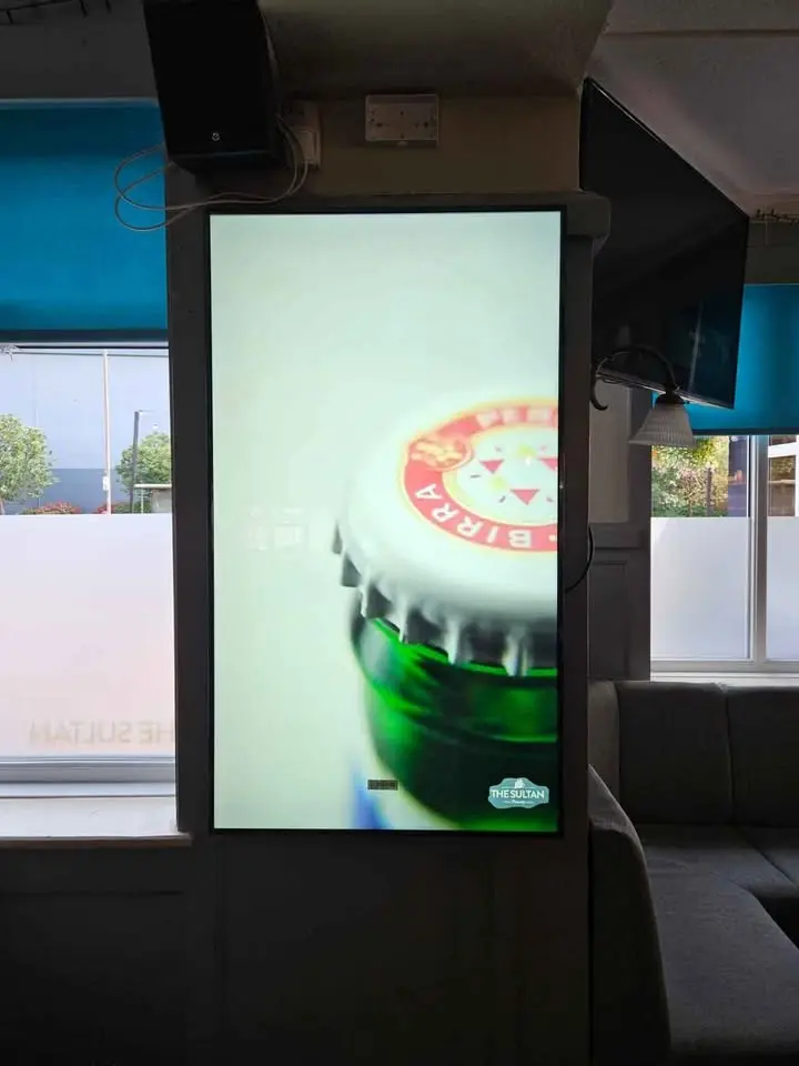 Pub digital signage displaying promotions and live sport schedule.