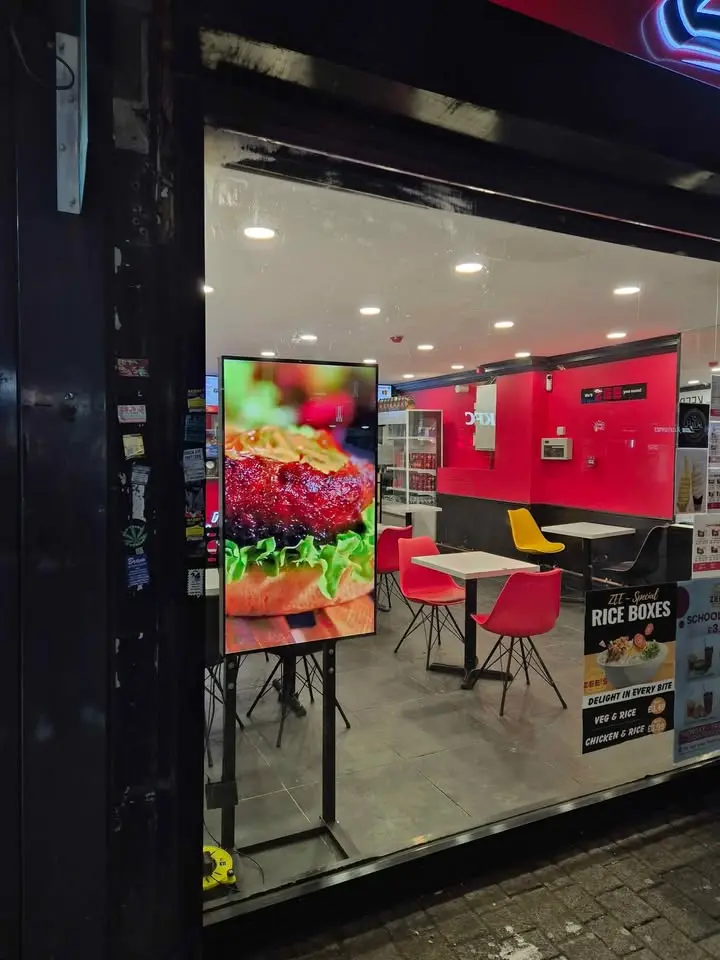 Digital signage showing new menu items and limited-time offers.